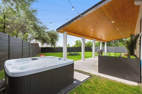 HUGE Backyard w/ 7 person Hot tub, Outdoor surround sound, Gas Weber BBQ pit, Patio seating around fire place, Corn hole yard game, large picnic table, hammock,  and a convenient half restroom for outside patio.