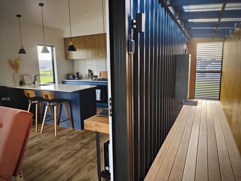Access to bedroom/ensuite via deck, embracing relaxed Kiwi bach living.