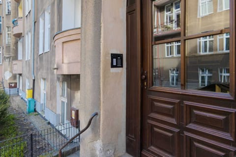 A classic exterior view of the building’s entrance, featuring detailed wooden doors and historical architecture.