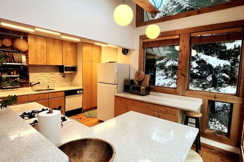 Fully equipped Kitchen with windows overlooking the rear yard
