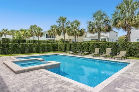 Enjoy a relaxing escape at this stylish outdoor space featuring a sparkling pool and comfortable sunbathing chairs. The sleek design and serene atmosphere create the perfect spot to unwind and soak up the sun in style.