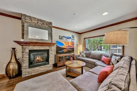 Sink into the plush sectional by your stone fireplace, where crackling flames and mountain views create the perfect evening retreat.