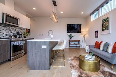 Cute and funky modern living space with full kitchen, easily seat 4 at the island for lunch or dinner. Two comfortable couches to sit on while you play games or watch TV!