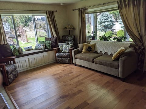 Living room with window seat overlooking the garden and bird feeders