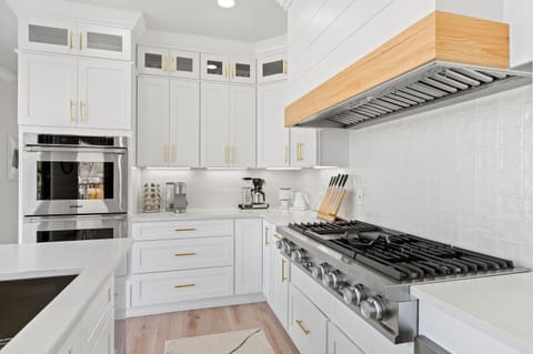 Welcome to our culinary haven, where the heart of the home takes center stage—a kitchen equipped with a magnificent 48" range cooktop that embodies the art of cooking.