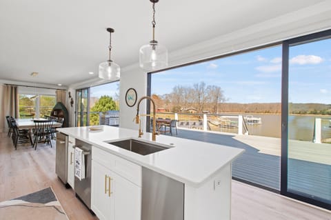 Effortlessly host gatherings with our functional and beautiful kitchen island bar, complete with two dishwashers and scenic lake views.