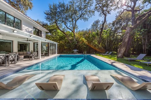 Sun soaked loungers by the private pool oasis