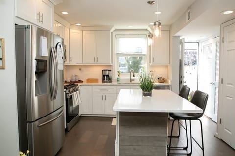 Bright kitchen with back door leading to lovely garden patio with hammock and chairs for lounging and al fresco dining. Washer and dryer in closet on right, 1/2 bath on right also. Welcome basket of goodies!