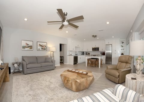 Living area, open to kitchen, marina view, 85-inch smart TV, double sleeper sofa