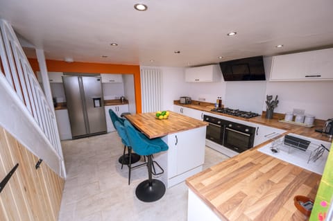 Kitchen with Oven, hob. fridge freezer, microwave. air fryer .toaster. kettle. washing machine, tumble dryer, tea towels and cleaning products