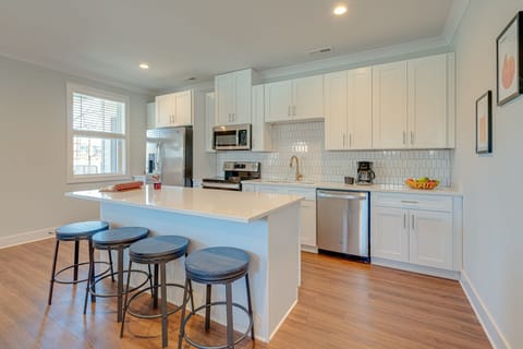 Bright open kitchen stocked with your basic cooking essentials. Complete with stainless steel appliances and breakfast bar seating. -Unit 1-