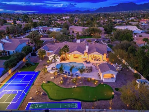 Stunning desert resort estate nestled in a mountain-framed neighborhood, featuring a private pool, sports court, and putting green—an oasis in a serene residential setting.