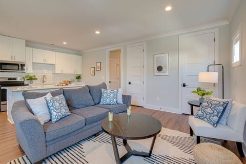 1st Unit: Modern Living Space featuring designer furnishings and a flat-screen SMART TV overlooking the fully equipped kitchen.