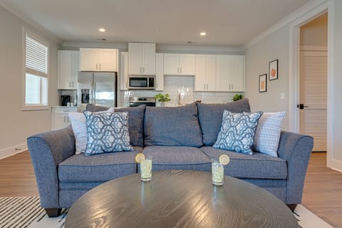 1st Unit: Modern Living Space featuring designer furnishings and a flat-screen SMART TV overlooking the fully equipped kitchen.