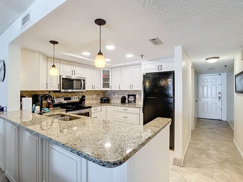 Fully equipped kitchen boasts granite countertops 