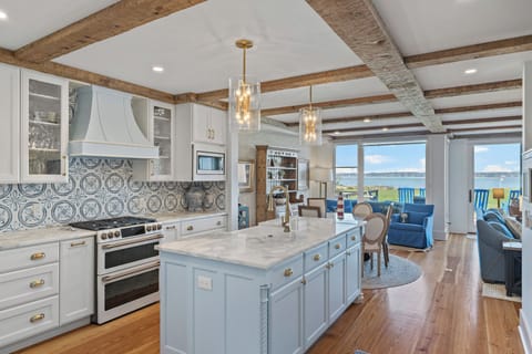 The kitchen offers ample counter space, stainless steel appliances, is fully stocked, and provides beautiful views of the golf course.