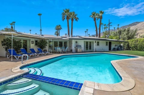 Private rear yard with pool/spa, grill, and mountain views