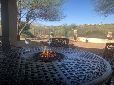 Backyard fire-pit table with view of back yard.