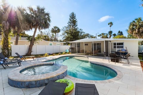 Enjoy a private backyard, with heated salt water pool and spa, screened lanai, gas fire table, gas grill.  All new furnishings. And just 2-3 min walk to the beach and fun activities!