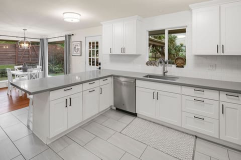 Renovated kitchen with shaker cabinets, quartz counters, and everything stocked and ready