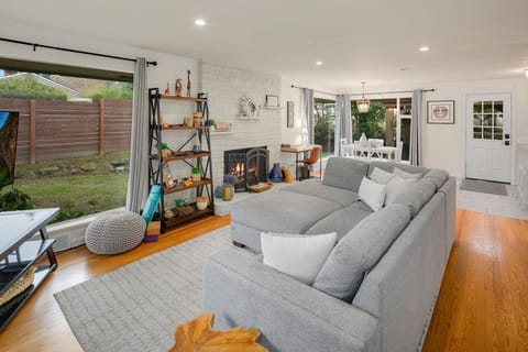 Sink into the plush gray sectional and enjoy the natural light pouring through large picture windows