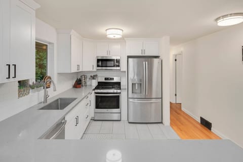 Gas range, quartz counters, stainless appliances — a proper kitchen for cooking real meals