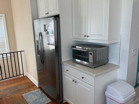 Sleek white cabinetry creates your perfect cooking haven with stainless steel appliances and plenty of storage for all your culinary adventures.