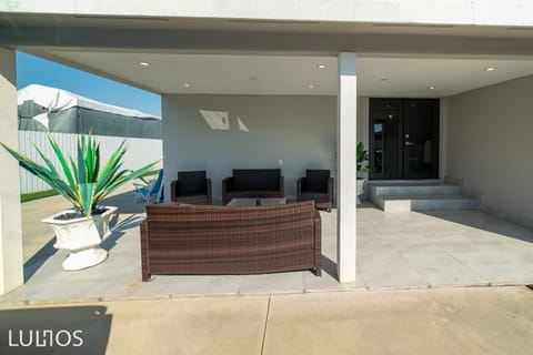 Patio with heated pool and outdoor furniture 