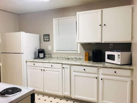 The kitchen is fully stocked with plates, pots, spices and even a bread maker!