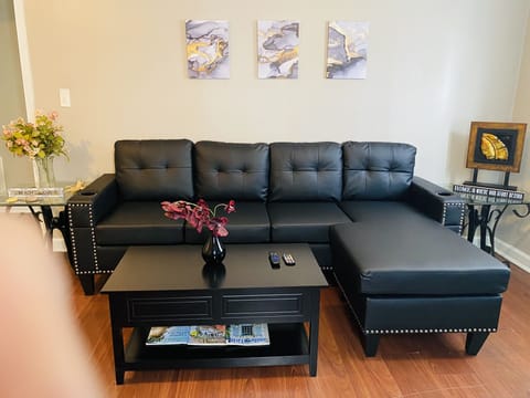 Netflix and chill in the living area with theatre style vegan leather sofa!