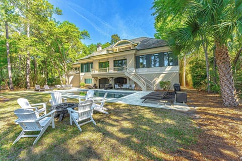 Stunning backyard retreat with a sparkling pool, lounge seating, and shaded patio areas—ideal for entertaining or relaxing in a private oasis.