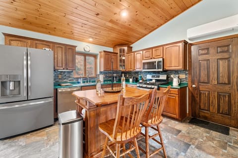  Kitchen with views of the backyard woods and deck area. 