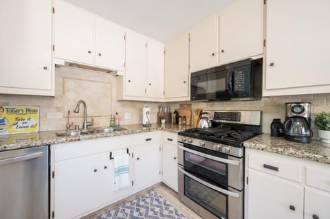 Full kitchen with stainless steel appliances double oven and griddle
