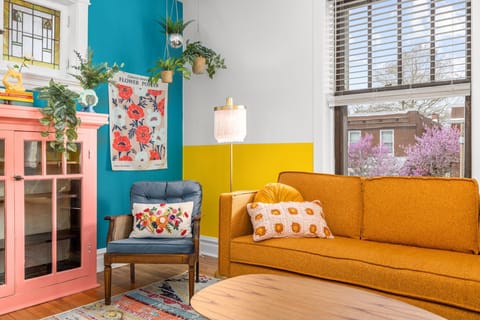 Welcome to our bright a vibrant living room. This is a great place to relax!