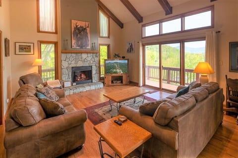 Huge great room with spacious ceilings surrounded by window create your mtn view