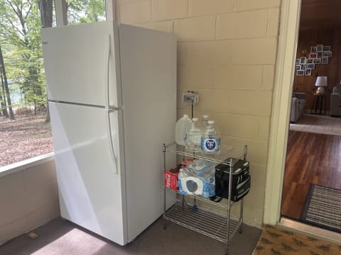 We currently keep the refrigerator on the covered front porch to maximize space.