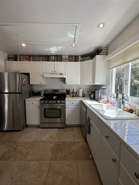 full kitchen w/ oven, stove, fridge, dishwasher, sink, glassware, utensils, etc