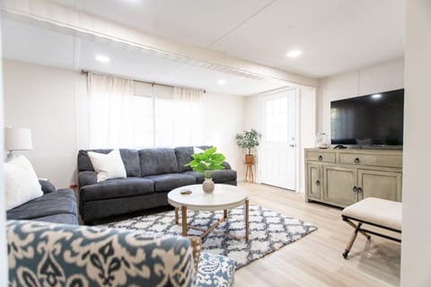 Spacious living room with lots of seating and 55” television