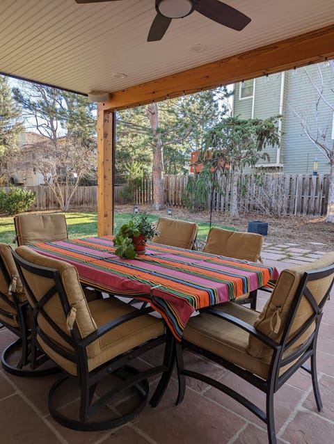 Enjoy the comfort of covered seating in the inviting backyard.