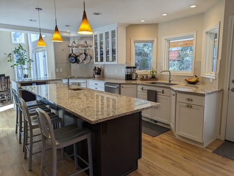 Well-appointed kitchen opens to backyard with seating.
