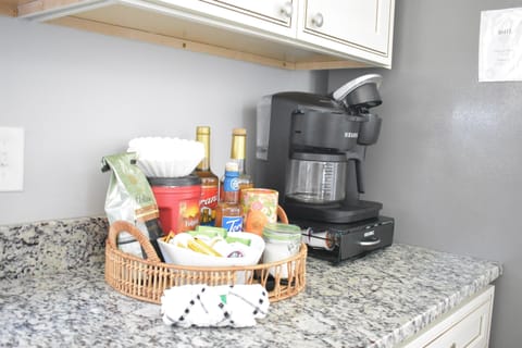 Grab your morning hot beverage from the coffee station with dual Keurig that includes drip coffeemaker with an unusually large assortment of coffee supplies.