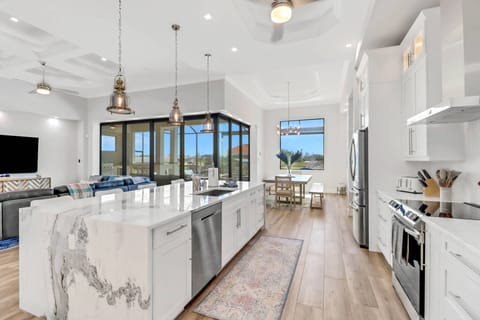 Upgraded appliances, quartz counters and custom cabinetry all elevate the design details of the open kitchen.