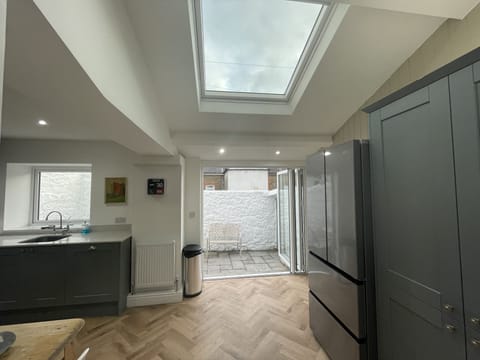 Kitchen flooded with natural light. Bi-fold to sunny enclosed rear yard.
