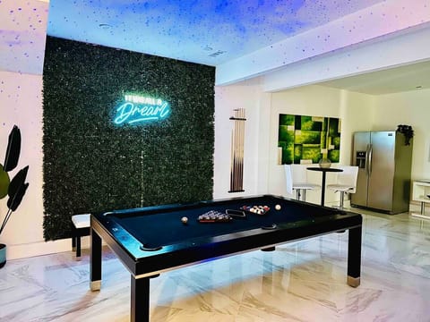 It was all a dream! in this amazing bottom level game and entertainment room. Billiards table sits under the starry overhead lights.