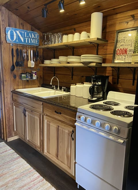 Galley kitchen with stove, refrigerator and microwave