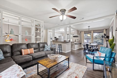 Open concept living area with dining table for 6 and fully stocked kitchen with breakfast bar