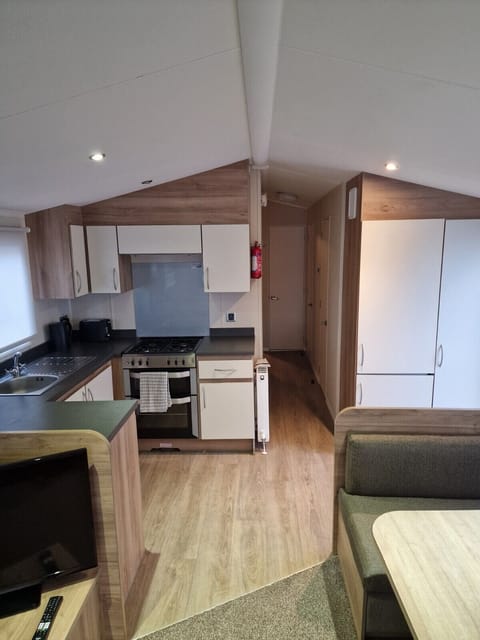 Kitchen with passageway and refrigerator