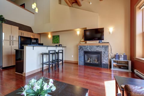Love this open-concept layout! A seamless flow connecting the cozy living room, dining space, and elevated loft level.