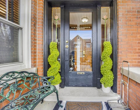 Twin ferms with stained tulip glass along with gold foil lettering confirm you have arrived.