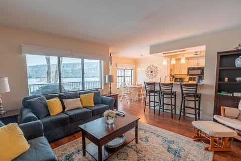 Enjoy lounging in the spacious living room with lake and pool views!
